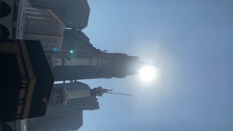 Titling-Shot-of-Clouds-and-Diverse-Muslim-People-Doing-Tawaf-Surrond-The-Kaaba-at-Al-Haram-Mosque