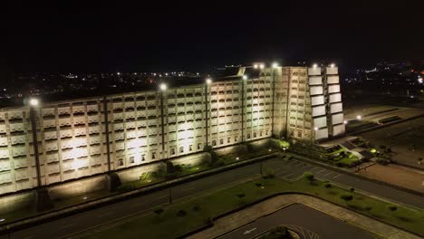 Night-drone-pullback-from-lit-up-cross-shaped-concrete-monument-Faro-a-Colon