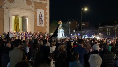 We-see-the-Virgin-of-Sorrows-in-white-with-a-black-cloak-carried-by-her-parishioners-behind-the-priests-leaving-the-parish-and-at-night-they-advance-at-a-slow-pace-people-take-photos