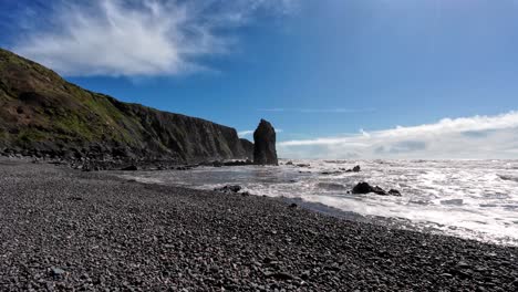 Seascapes-sea-stack-shingle-beach-sea-cliffs-blue-sky-at-Ballydwane-beach-in-Waterford-Ireland