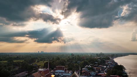 A-timelapse-of-sun-beams,-the-clouds-and-river-life-over-the-Chaopraya-River-and-Koh-Kret-Island-outside-of-Bangkok-Thailand