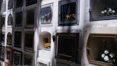 Mausoleum-niches-hold-family-memorials-in-tree-shaded-Bolivia-cemetery