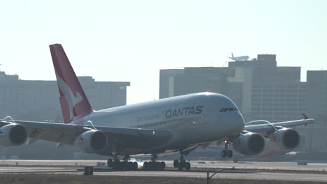 A-Qantas-Airlines-Airbus-A380-lands-on-Runway-24R-at-Los-Angeles-International-Airport,-filmed-in-slow-motion