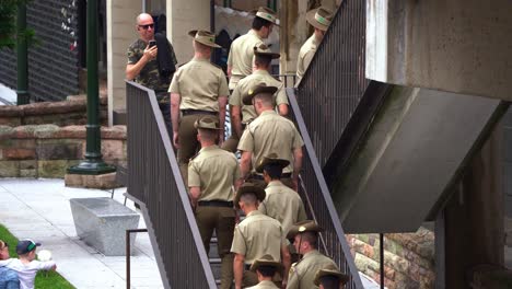 Young-uniformed-cadets-walking-up-the-stairs-to-the-sky-bridge-crossing-at-Brisbane-city-during-Anzac-Day-before-the-start-of-parade-tradition