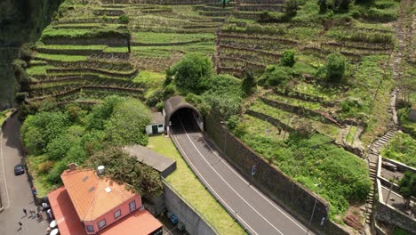 Seixal-village-terraced-hillside-aerial-view-circling-João-Delgado-mountain-road-tunnel-entrance
