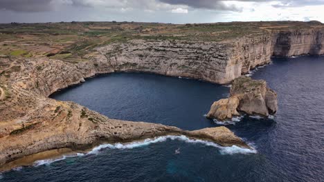 Aerial-view-of-Fungus-Rock-in-Dwejra-Bay,-Gozo