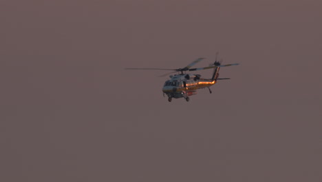 A-Los-Angeles-County-Fire-helicopter-flies-over-downtown-LA-on-the-way-to-a-nearby-wildfire