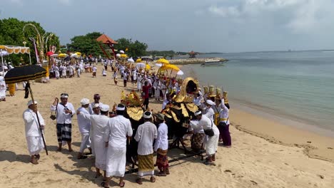 Balinese-Hindu-religious-congregations-perform-a-melasti-ceremony,-ahead-of-the-quiet-day-of-Nyepi-on-Samuh-beach