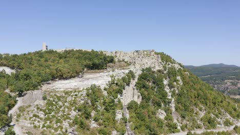Approaching-drone-shot-of-the-ancient-historical-landmark-of-Perperikon,-built-on-a-rocky-hilltop,-located-in-the-province-of-Kardzhali-in-Bulgaria