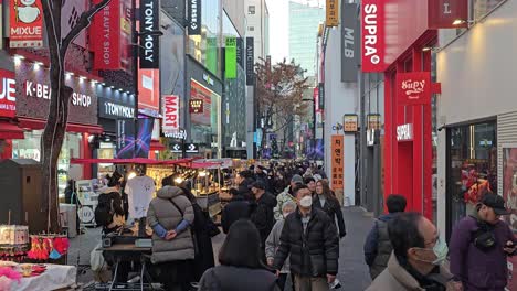 Tourists-walk-by-street-stalls-at-Myeongdong-market-in-Seoul