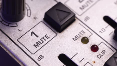 Muting-Channel-1-on-Mixing-Audio-Console,-Pressing-Mute-Button,-Macro-Close-Up