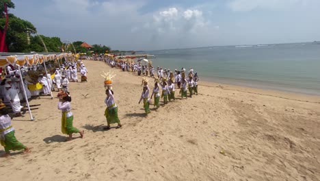 Balinese-Hindu-religious-congregations-perform-a-melasti-ceremony,-ahead-of-the-quiet-day-of-Nyepi-on-Samuh-beach