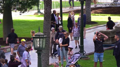 Old-veteran-accompanied-by-his-loving-wife-walking-down-the-path-of-Anzac-Square-on-Anzac-Day