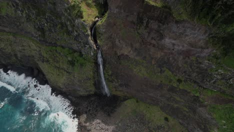 Madeira-Véu-da-Noiva-viewpoint-aerial-Birdseye-view-rising-up-lush-rocky-Atlantic-ocean-coastal-waterfall-cliff
