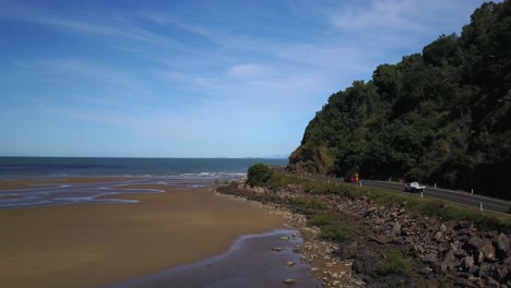 Video-Aéreo-De-Automóviles-Que-Viajan-Por-Una-Carretera-Junto-Al-Mar,-En-Queensland,-Australia.