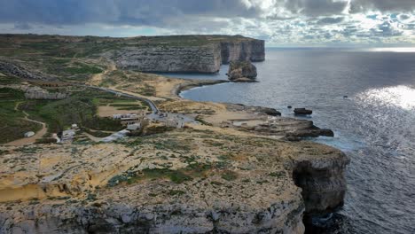 Drone-view-of-Dwejra-Bay-with-Fungus-Rock,-colapsed-Azure-Window,-underwater-cave