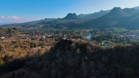 Partial-180-degree-drone-shot-of-an-unknown-buddhist-temple-in-the-Sangklaburi-District-in-the-northwest-of-Thailand-near-the-golden-hour