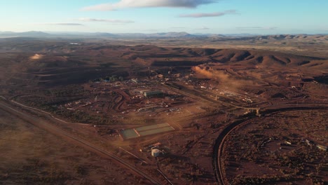 Aerial-Establishing-shot-of-Marandoo-Iron-mine-site-in-Australian-desert-landscape-at-sunny-day