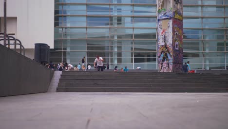 Person-jumps-down-stair-on-their-skateboard