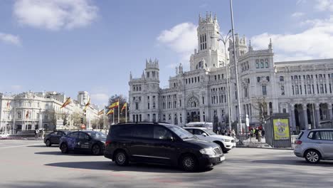 View-of-the-busy-roundabout-at-Cibeles-fountain-with-the-iconic-tourist-attraction-of-Cibeles-palace-in-Madrid