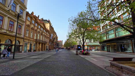 People-walk-at-czech-republic-prague-city-old-houses-cobblestone-path-autumn-day-clear-skyline,-european-travel-destination-town