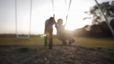 Happy-father-and-son-playing-outside-in-sunset-in-cinematic-slow-motion