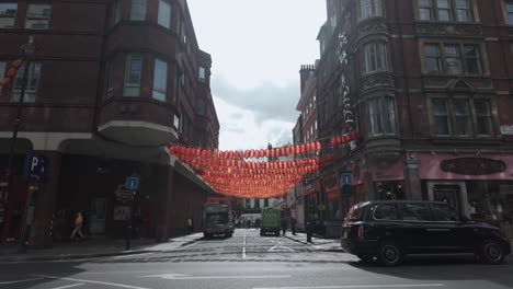 Red-Hanging-Lanterns-Swaying-Along-Gerrard-Place-Viewed-From-Shaftesbury-Avenue-Near-Chinatown,-London