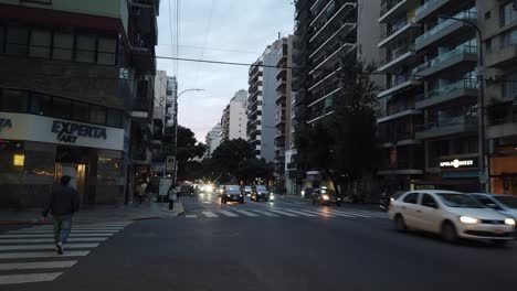 Cars-driving-at-corrientes-avenue-buenos-aires-City-landmark-hyperlapse-traffic-in-motion-and-people-pedestrians-walking-by