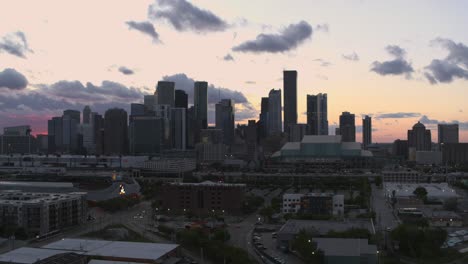 Drone-shot-moving-to-the-left-of-downtown-Houston,-Texas-during-sunset