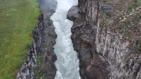 Aerial-View-of-River-Canyon-and-Gullfoss-Waterfall,-Natural-Landmark-of-Iceland,-Revealing-Drone-Shot