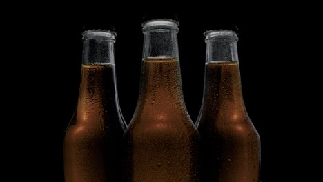 Coke-bottles-showcased-against-a-black-backdrop-illuminated-and-reflecting-dynamic-angles-of-light