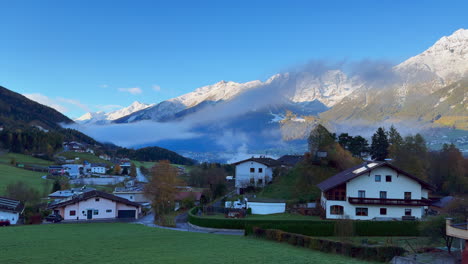 Early-November-Europe-Australian-Swiss-Alps-fall-autumn-Stubai-Village-chalet-Tirol-Austria-first-light-morning-sunny-sunrise-first-snow-on-peaks-cloudy-foggy-Innsbruck-chalet-landscape-pan-left