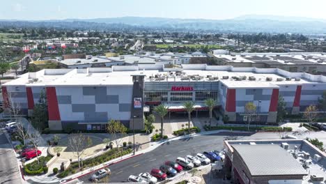 Harkins-Movie-Theater-in-Mountain-Grove-Shopping-Center-in-Redlands-California-on-a-sunny-day-timelapse-AERIAL-TRUCKING-PAN