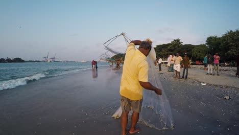 Fishing-man-arranging-his-fishing-net-before-throwing-it-into-the-water-for-another-fishing-attempt