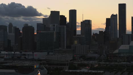 Drone-shot-moving-to-the-right-of-downtown-Houston,-Texas-during-sunset