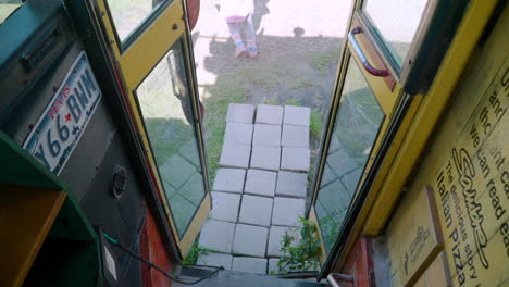 Toddler-walks-down-steps,-out-bus-door,-Munyeodo-Bus-Cafe,-Gunsan,-South-Korea