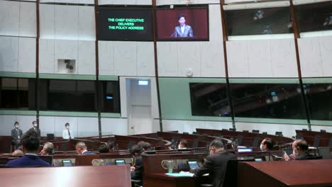 Carrie-Lam,-former-Hong-Kong's-chief-executive,-is-seen-on-the-main-chamber's-screen-as-she-delivers-the-annual-policy-address-at-the-Legislative-Council-building