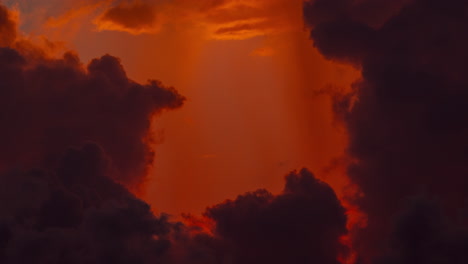 Close-up-vibrant-backlit-cumulus-clouds-changing-during-a-sunrise-time-lapse