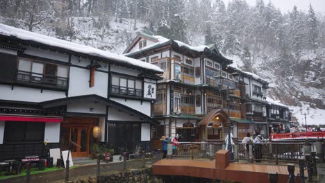 Slow-motion-pan-as-snow-falls-in-mountain-resort-town