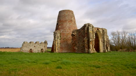 Wide-shot-of-St-Benet’s-abbey-16th-century-gatehouse-with-18th-century-windmill