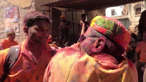 pov-shot-Many-people-are-coming-from-Road-and-many-people-are-flying-a-color-from-the-side-and-walking-towards-the-temple