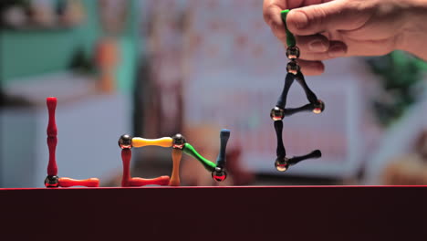 Magnetic-sticks-and-balls-toy-spell-out-LOVE---concept