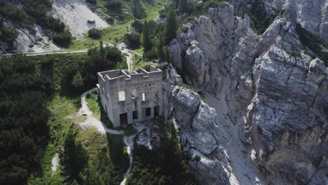 Derelict-abandoned-building-in-remote-rocky-mountainous-area-Aerial-orbital