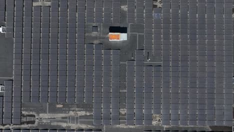 Aerial-top-down-shot-of-solar-panels-on-large-building-of-shopping-mall