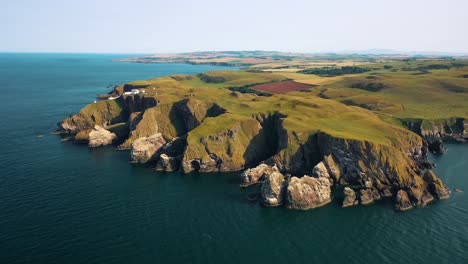 Iconic-Scottish-Seascapes:-Aerial-Over-St-Abbs-Head-Lighthouse,-Scottish-Coast,-Scotland