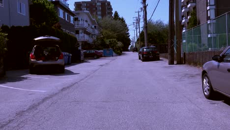 Dolly-shot-walking-along-back-lane-on-sunny-day