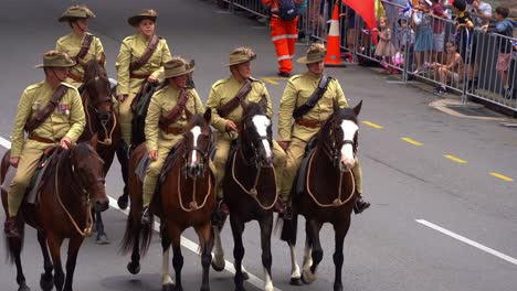 Troops-from-the-Australian-Defence-Force-mounted-on-horseback-ride-down-the-street,-participating-in-the-annual-Anzac-Day-parade