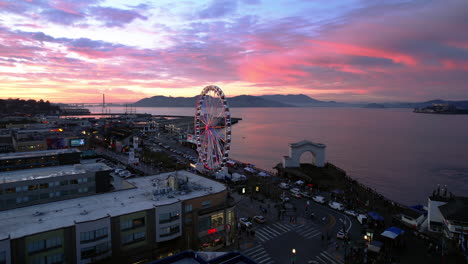 San-Francisco-USA,-Aerial-View,-SkyStar-Ferris-Wheel,-Piers-and-Bay-After-Sunset