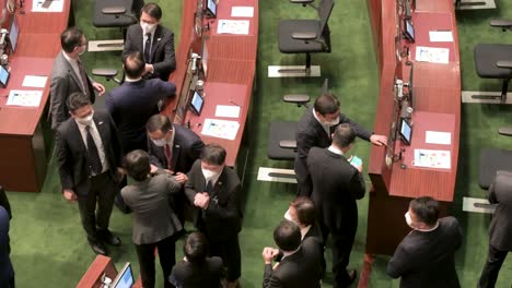 Hong-Kong-lawmakers-greet-and-talk-to-each-other-at-the-main-chamber-moments-before-the-arrival-of-the-chief-executive-at-the-Legislative-Council-building-in-Hong-Kong