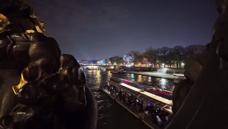 Péniche-typical-and-tourist-boat-navigation-along-Seine-River,-view-from-Pont-Alexandre-III-bridge,-Paris-by-night